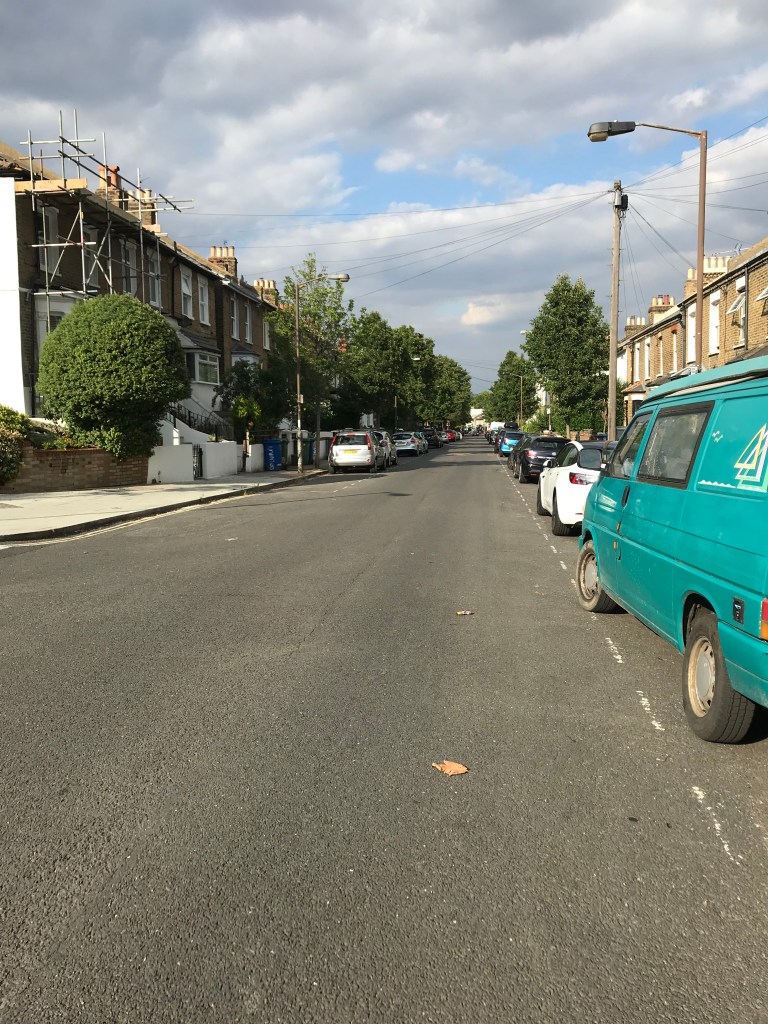 A long view of a road with trees either side